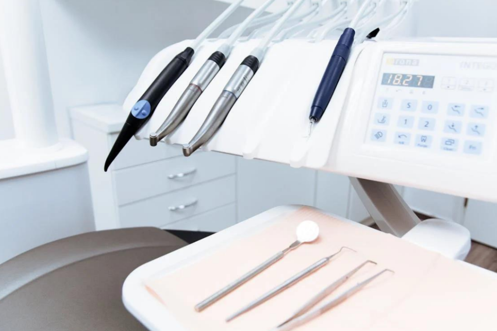 A pristine dentist’s workstation including instruments and machines.