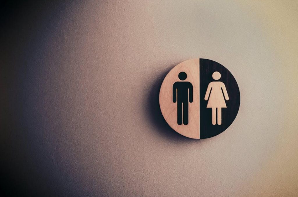 A male and female bathroom sign on a white wall.