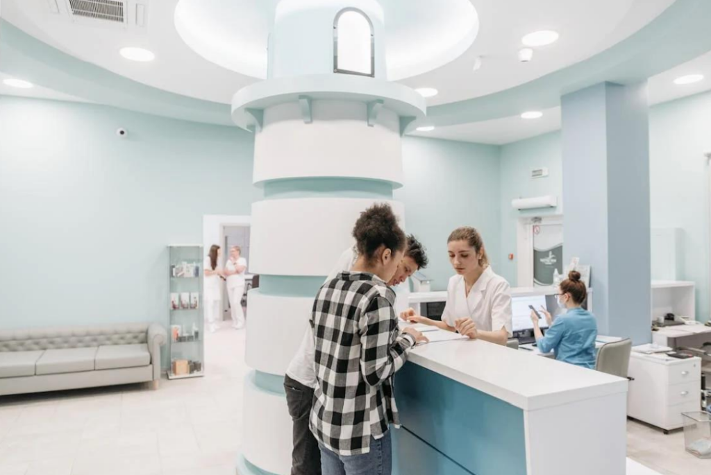 A man and woman checking in for a dental appointment