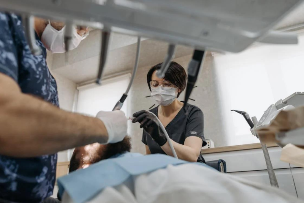 A dentist and dental nurse operation on a patient.